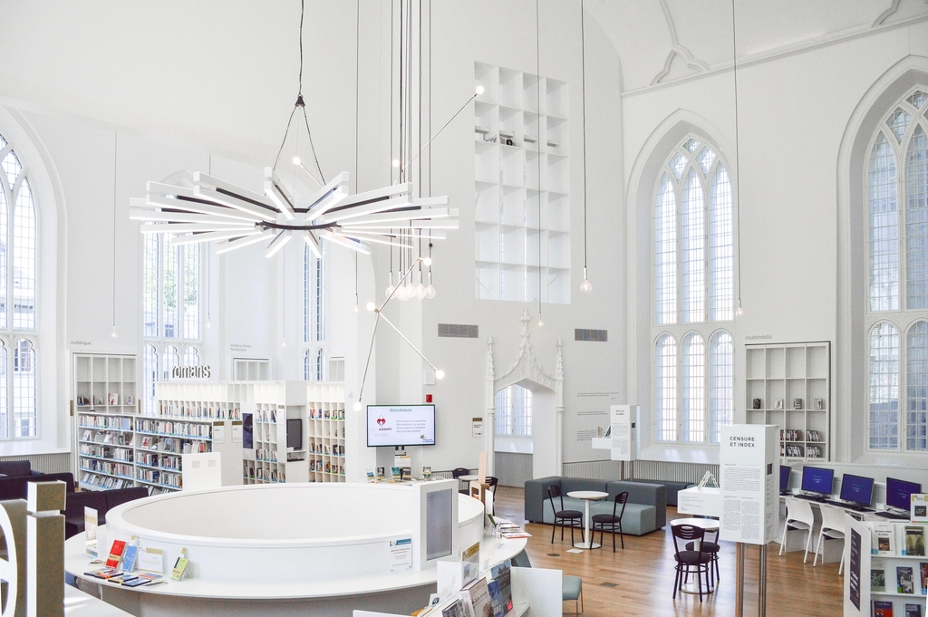 Bright open commercial interior with clean floors, clear desks and tall windows