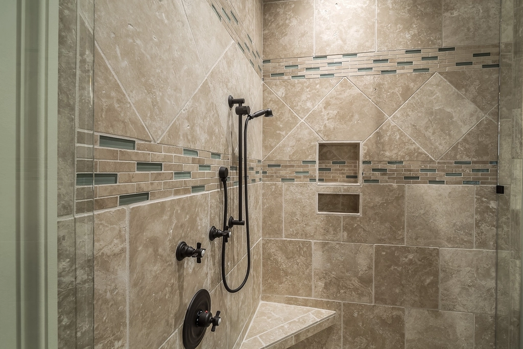Tiled shower and grout lines in a bathroom cleaned in detail